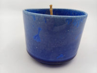 Side view of cobalt blue ceramic beeswax candle
