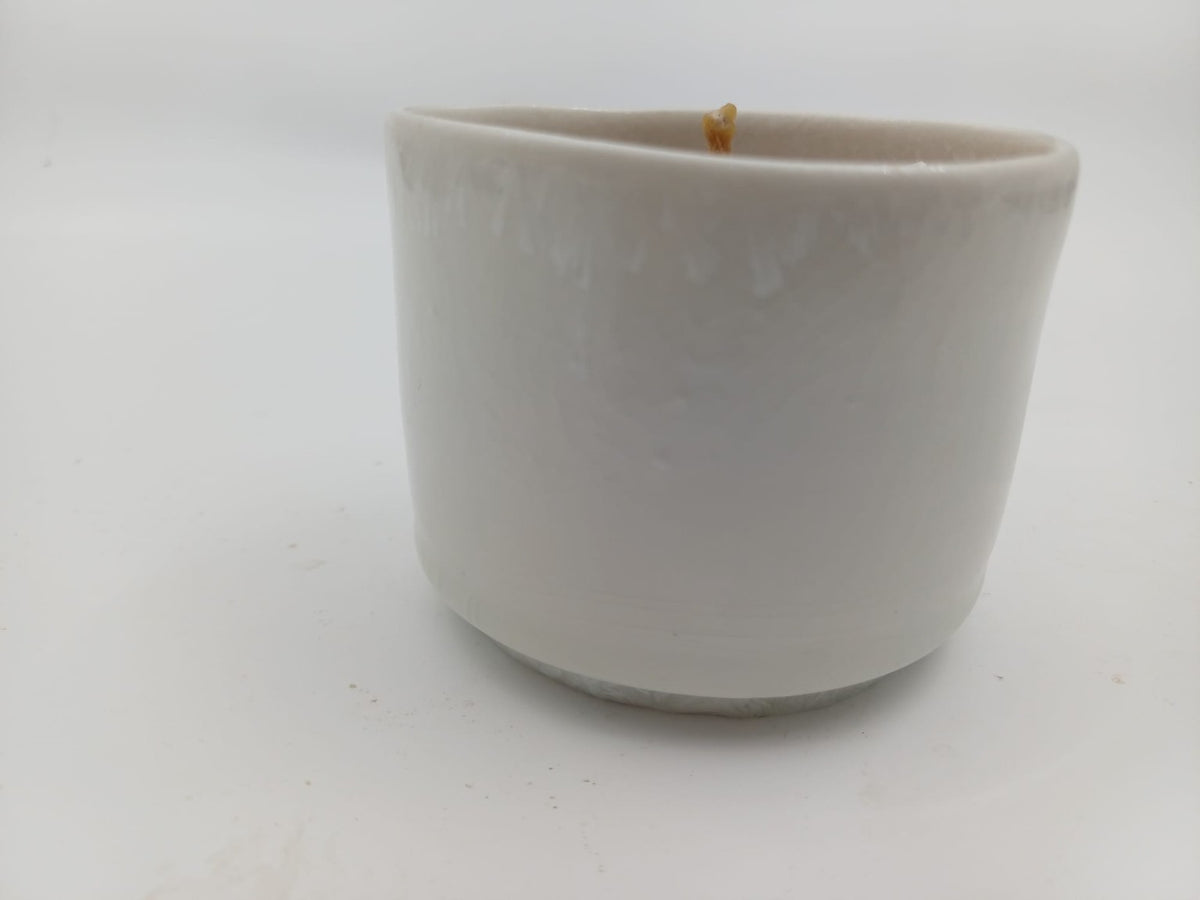 White glazed beeswax candle ceramic vessel side view