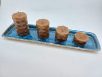 Alternate view of geometric beeswax candles on blue ceramic tray