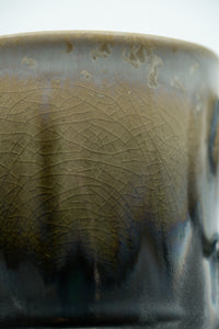Close detail of the ash, ivory and charcoal crystalline glaze