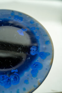 Close detail of cobalt crystals beside the ink-black centre