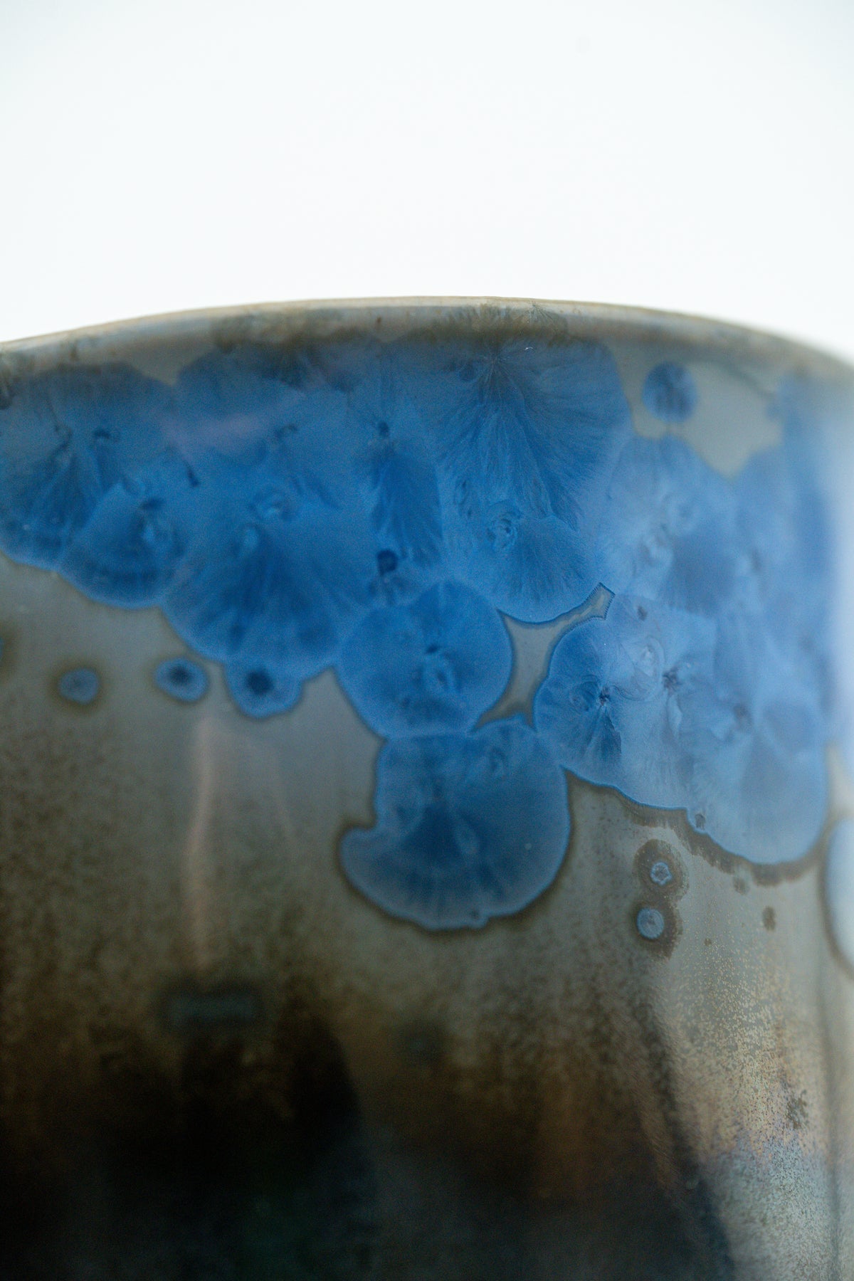 Close detail of cobalt crystals over a smoke-grey glaze